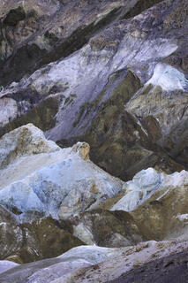 The chaotic soil collides with each other revealing a swirl of browns, whites, grey, blue, reds and more.  