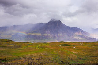 A rainbow appearing next to Castle Mountain in Alaska