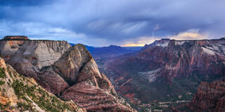The mountain of the sun, east temple and the west temple all in view with lightning dropping in the distance. 
