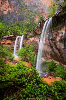 The lower emerald pools of zion with both waterfalls going during the summer so all plants are green and bright. 