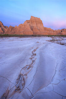 a mud crack leading the viewer into the distance where large mud castles exist. 