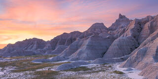 A panoramic image of badlands national park at sunset.