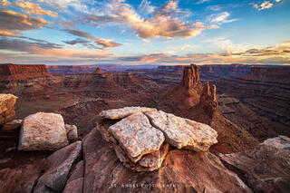 Malboro point in moab utah. A large tower stands in a canyon at sunset near moab utah