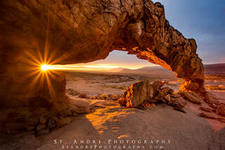 Sunset Arch in escalante at sunrise with the sun rising through the arch