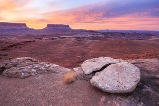 A wonderfully broken in half rock with an epic sunrise going on in the distance. 