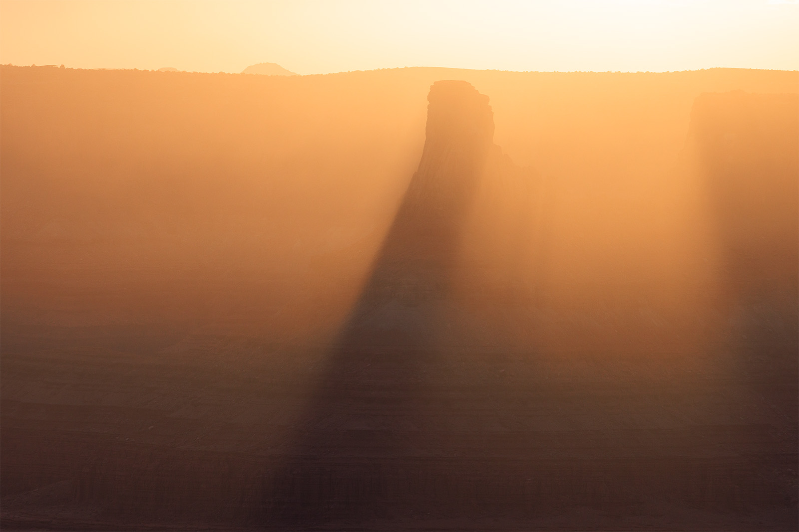 A God Rising A pillar of shadow is created due to a tower in the desert.