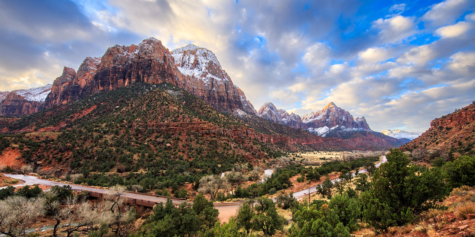 Bridge Mountain and Watchman Mountain in Zion National Park covered in a light powdering of snow at sunrise. 