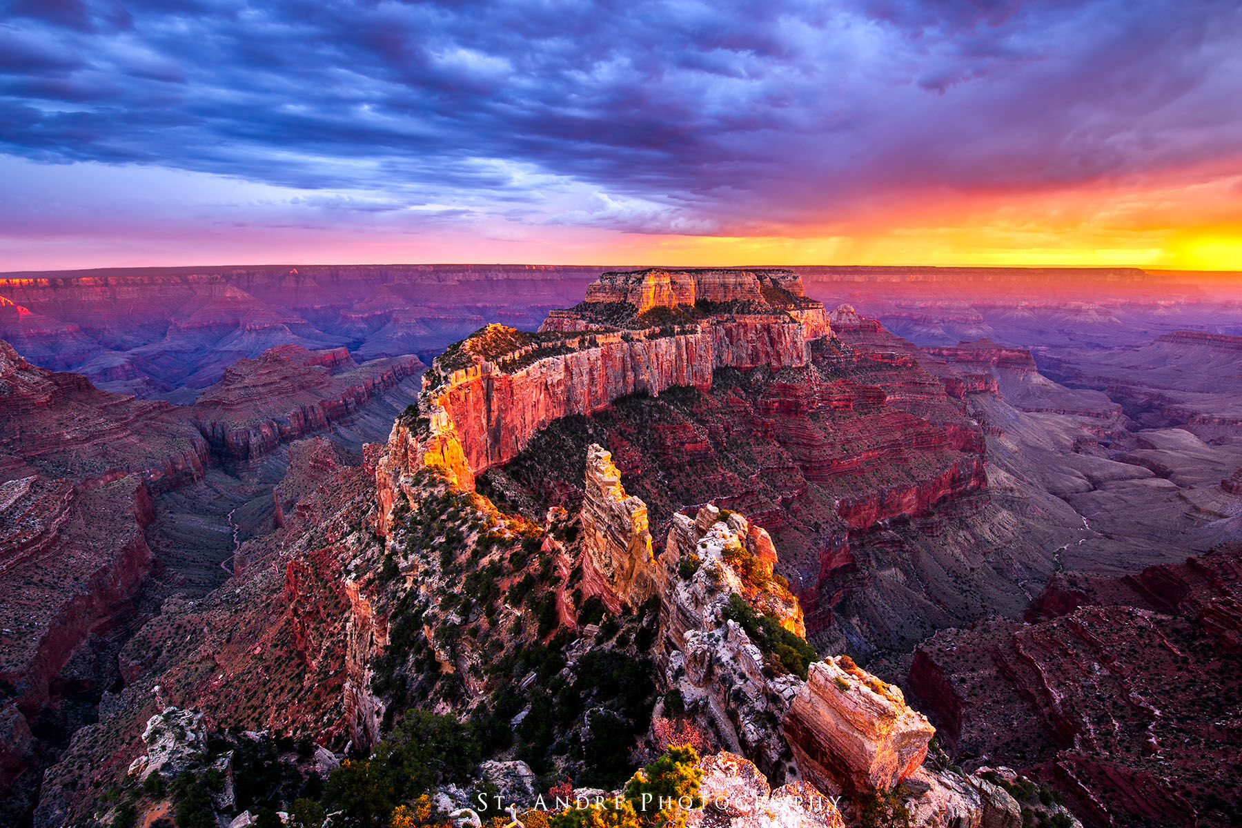 Cape Royal, Wotons Throne a large slender mesa juts into the grand canyon and is lit up by side light from a colorful sunset