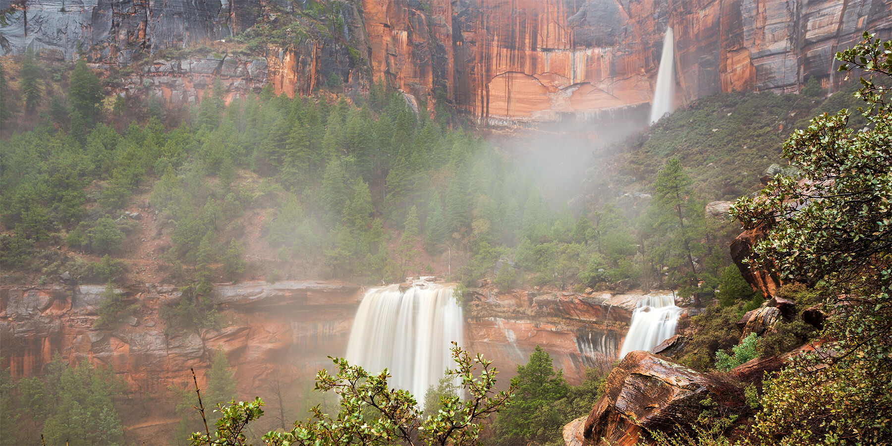 Emerald Pools in Zion National Park flooding at full capacity with three waterfalls in view. 
