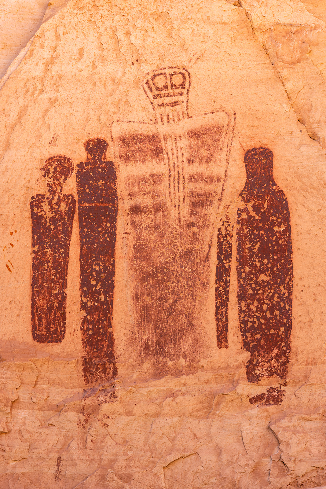 Holy Ghost Panel 4 ghostly figures painted onto a rock wall in the southern utah desert.