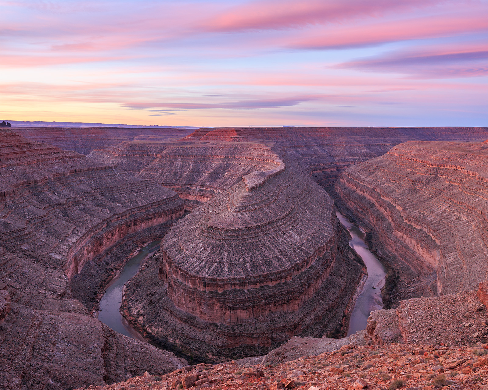 The Gooseneck A large canyon creating a geological feature called a gooseneck. The San Juan River quietly flows at the bottom of the canyon.