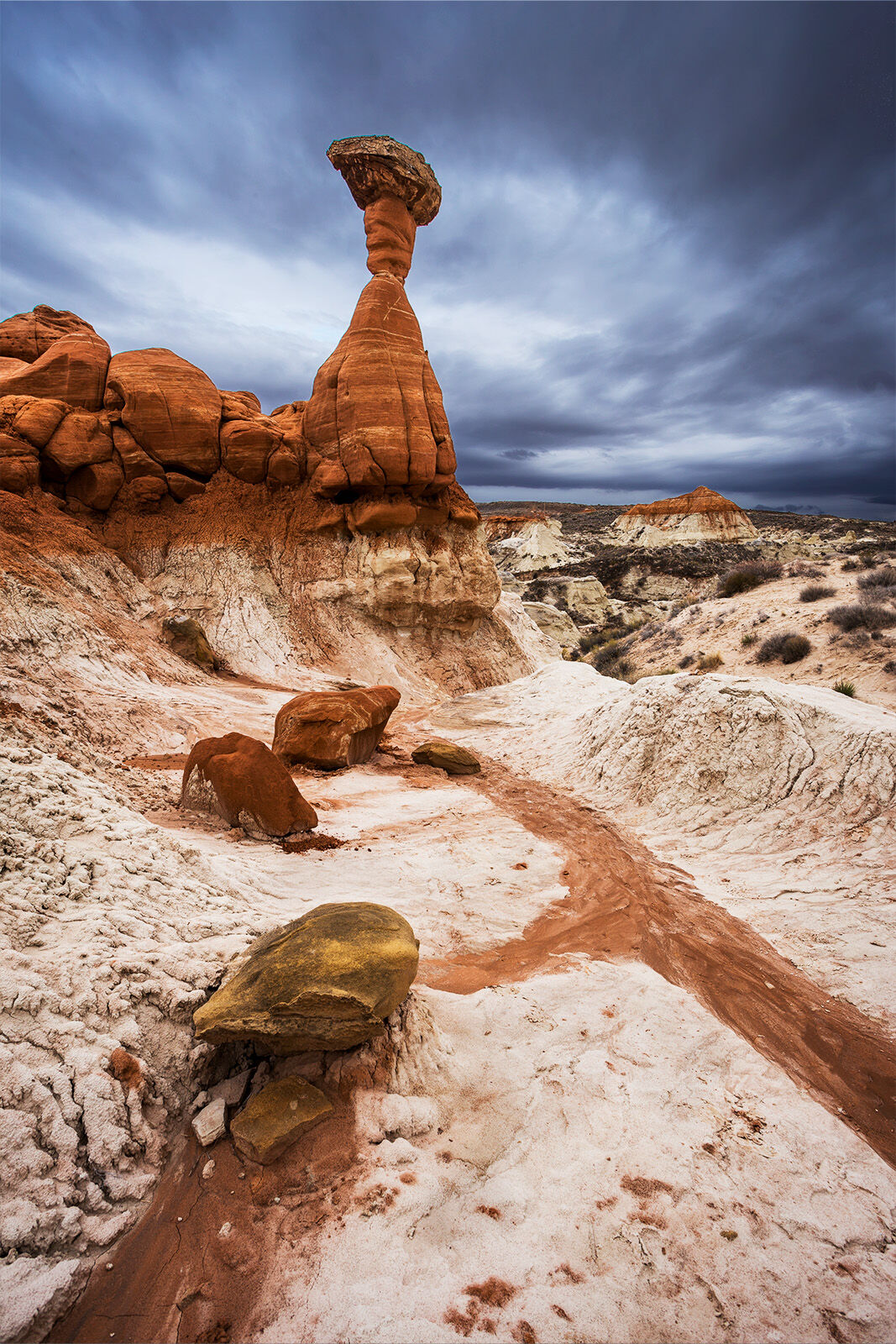 A large hoodoo stands tall in a desert landscape. Located near Kanab in Southern Utah with Grand Staircase Escalante National Monument. 