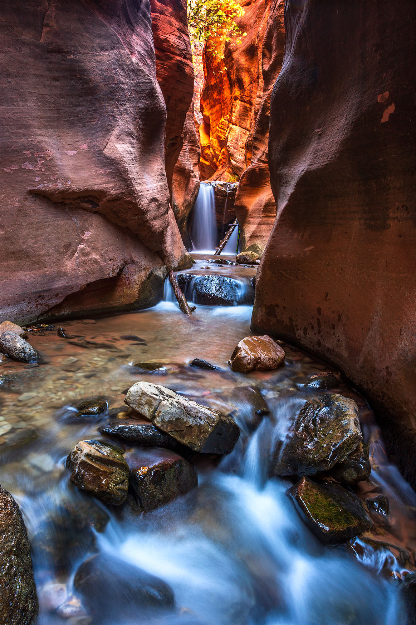 Upper Kanarraville Falls in Blue The upper waterfall at kanarraville falls, utah. The waterfall sits within a tight slot canyon.