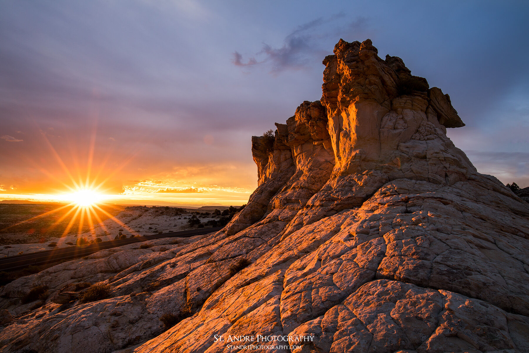 A large rock formation on the edge of Escalante Canyon with the rising sun.