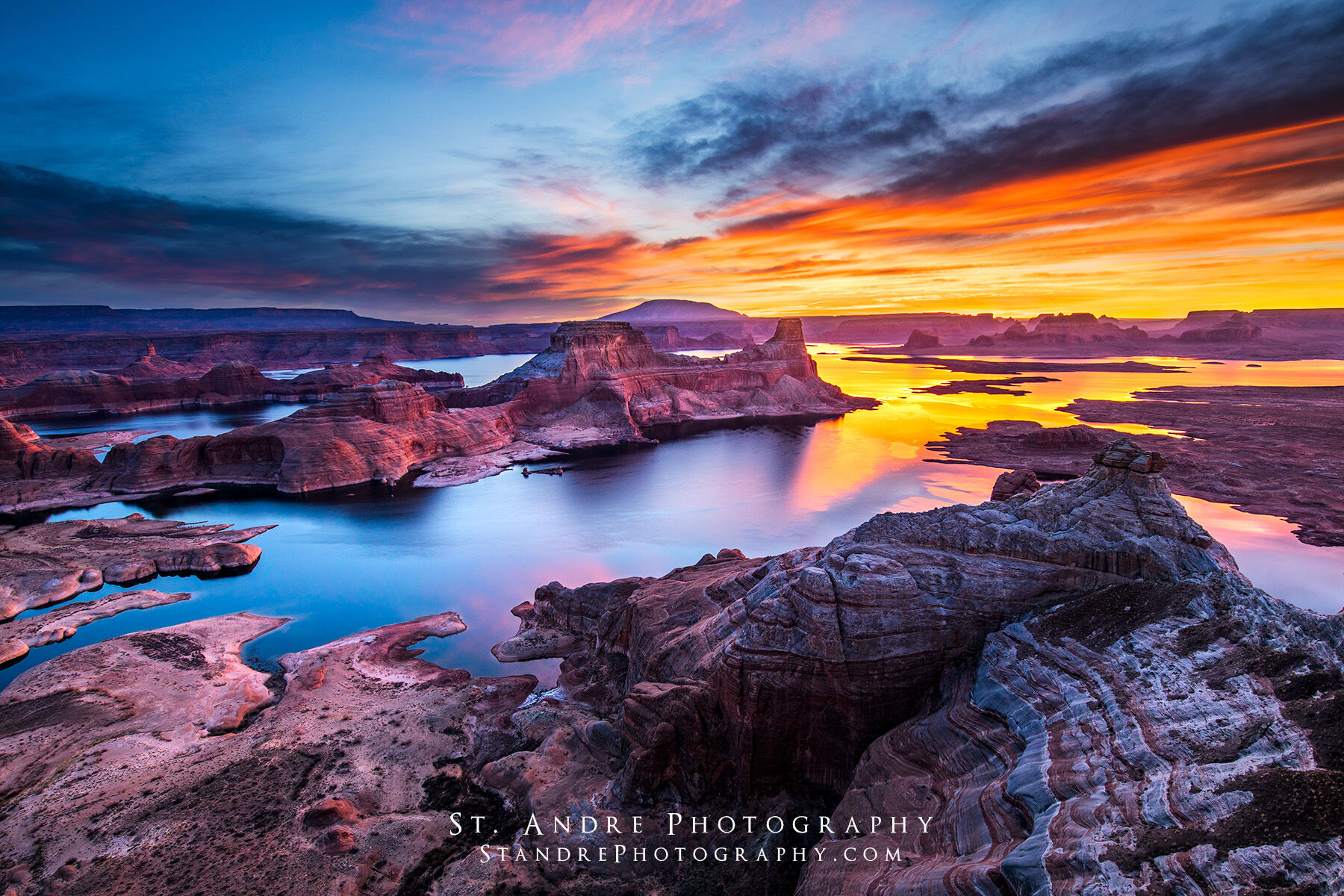 Alstrom point in Lake Powell at sunrise. Gunsight butte can be seen in the middle of padre bay