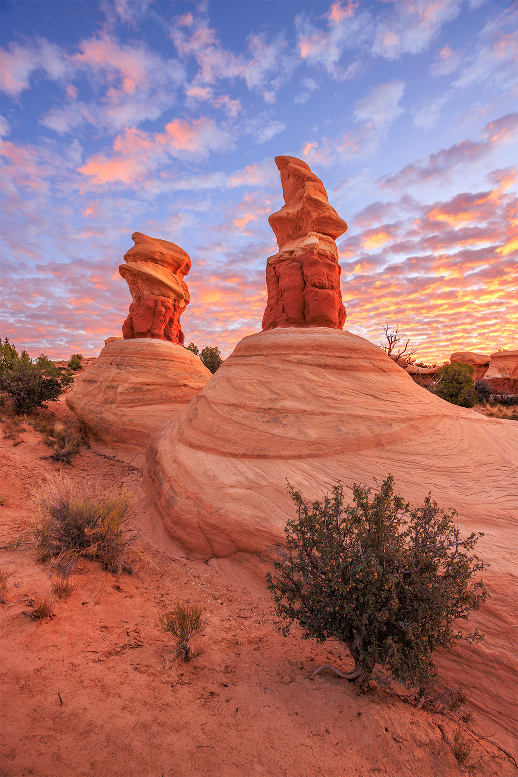 Two Towers At Dawn two hoodoo's at sunrise with bands of color in the sky.
